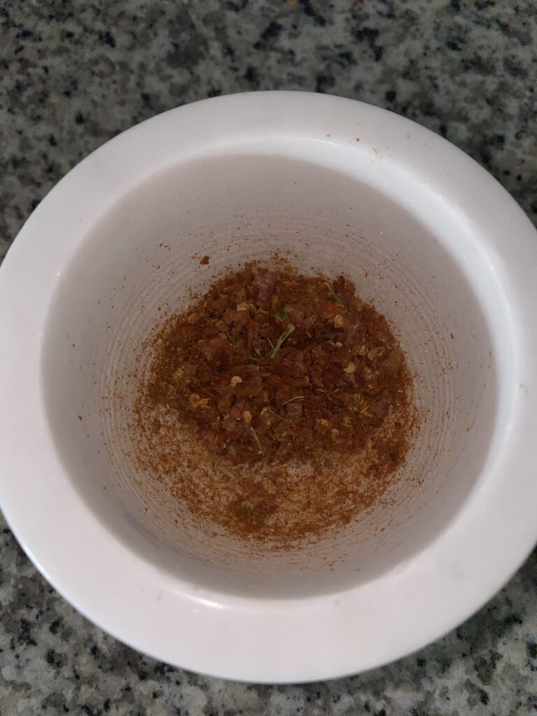 cayenne peppers ground up using mortar and pestle